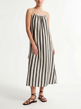 Woman wearing a black and white striped handloomed cotton dress on a white background