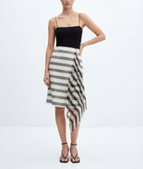 Woman wearing a black top and striped skirt on a white background