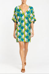 Woman wearing a V neck 3/4 Sleeve Short easy Dress in a green pink tropical leaves print 