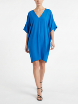 Woman wearing a cobalt blue silk dress with short kimono sleeve 
