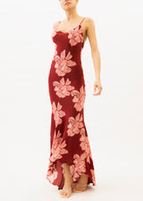 A model wearing a slip maxi dress with red and pink floral pattern