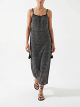 Woman wearing a black and white striped handloomed cotton dress on a white background