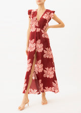 The model is wearing a Red and pink floral maxi dress with front slit
