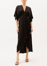 The model is wearing a Black silk maxi dress