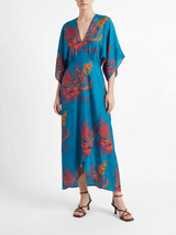 The model is wearing a Green Floral Maxi Dress