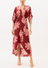 The model is wearing a Red and pink floral maxi dress