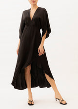 The model is wearing a black backless high-low dress