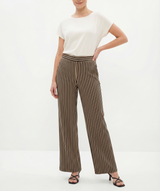 Woman wearing a white top and brown striped pants on a white background
