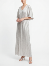 Woman wearing a silver pleated dress on a white background
