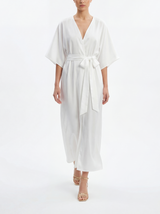 Woman wearing a white belted dress on a white background