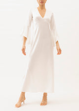 Model wears a white silk maxi dress