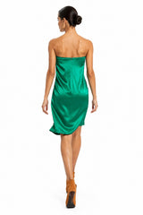 Woman wearing a green strapless dress on a white background
