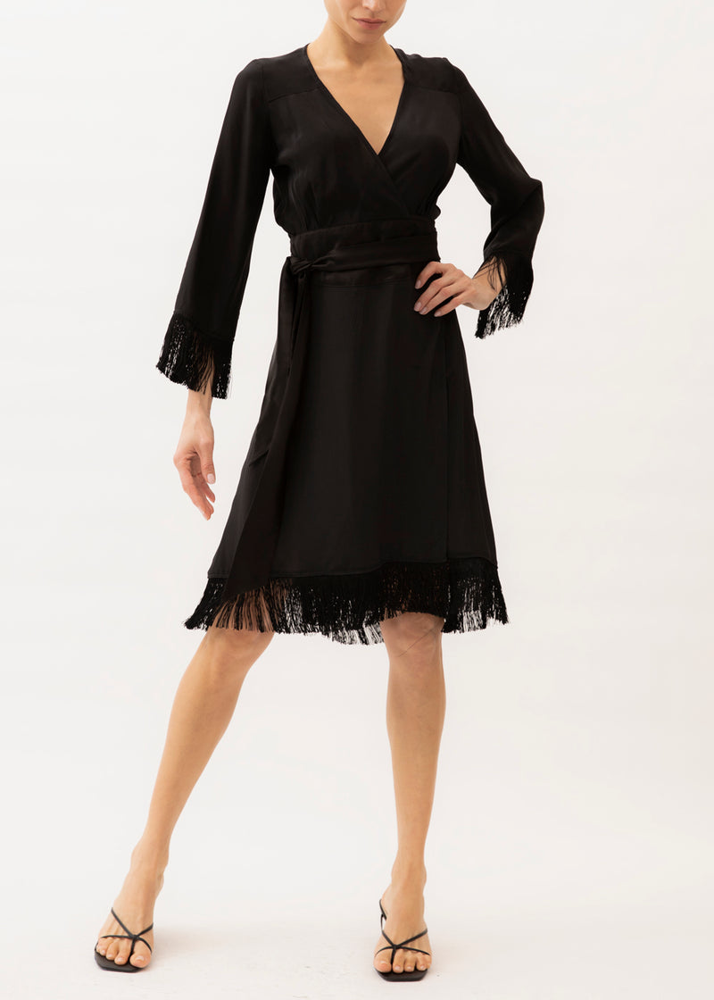 black wrap dress with fringe on the hemline and sleeves