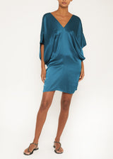 The model is wearing a Teal Silk Short Dress