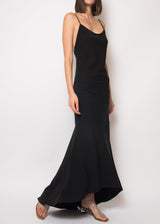 The model is wearing a Black silk open back dress