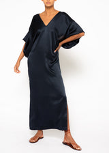 The model is wearing a Navy silk kimono maxi dress