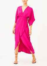 The model is wearing a long silk maxi pink dress