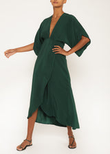 The model is wearing a emerald green maxi dress long dress with a Deep V surplice front emerald green maxi dress