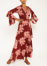 the model is wearing a full-length Bordeaux print wrap dress boasting angel sleeves with slits and a sewn-in belt 