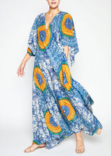 The model is wearing a Blue and yellow printed flowy full-length Kaftan dress that features a V neckline, and scarf-shaped sleeves